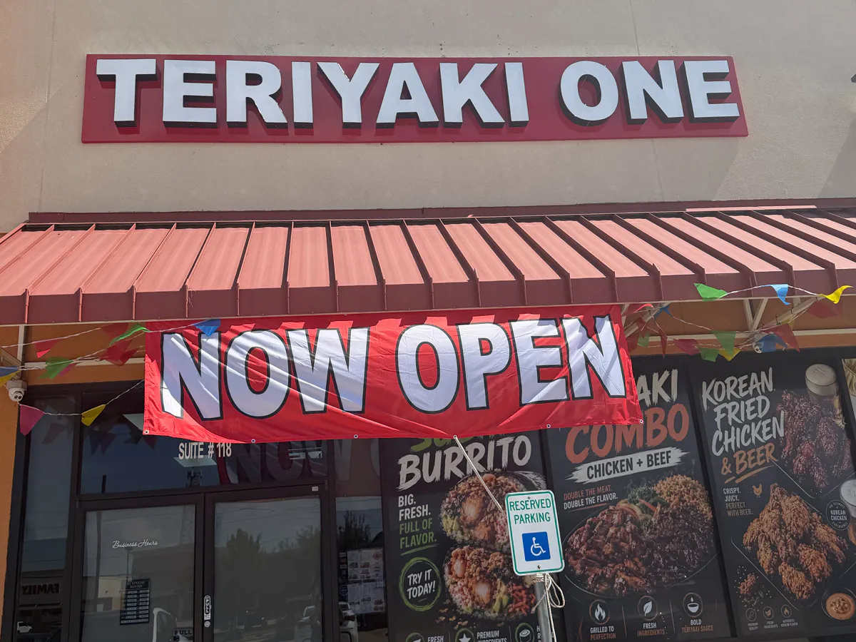 Teriyaki One restaurant entrance with a large “Now Open” banner Teriyaki One restaurant entrance with a large “Now Open” banner