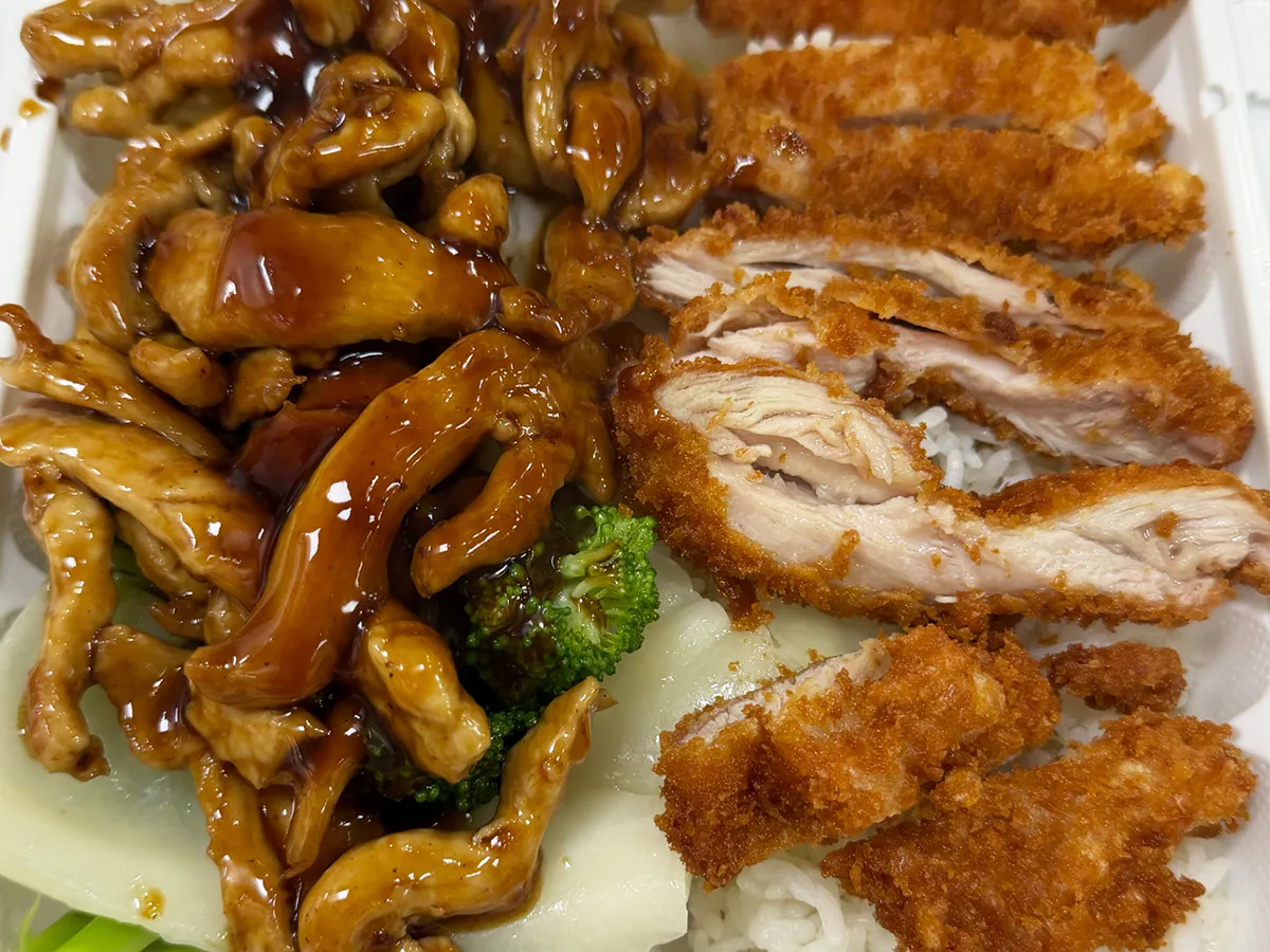 Teriyaki chicken and crispy chicken served with rice and broccoli